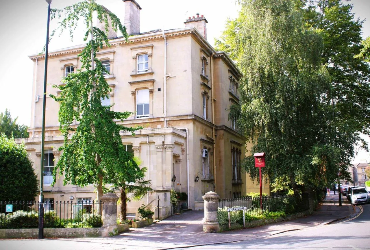 an old building with a tree in front of it at Victoria Square Hotel Clifton Village in Bristol